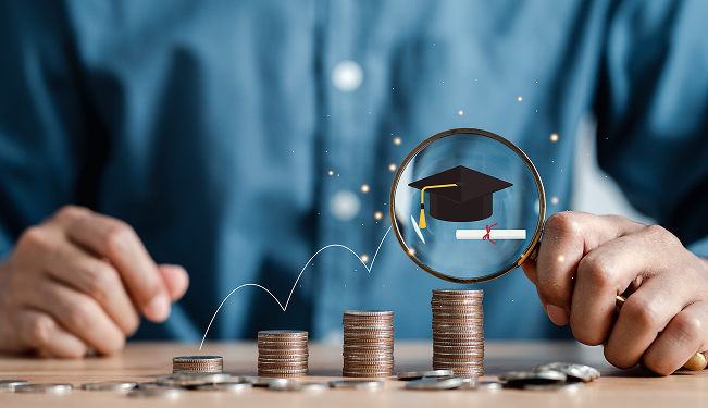 Student studying at a desk surrounded by financial paperwork