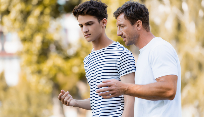 Two people reviewing and signing a loan agreement